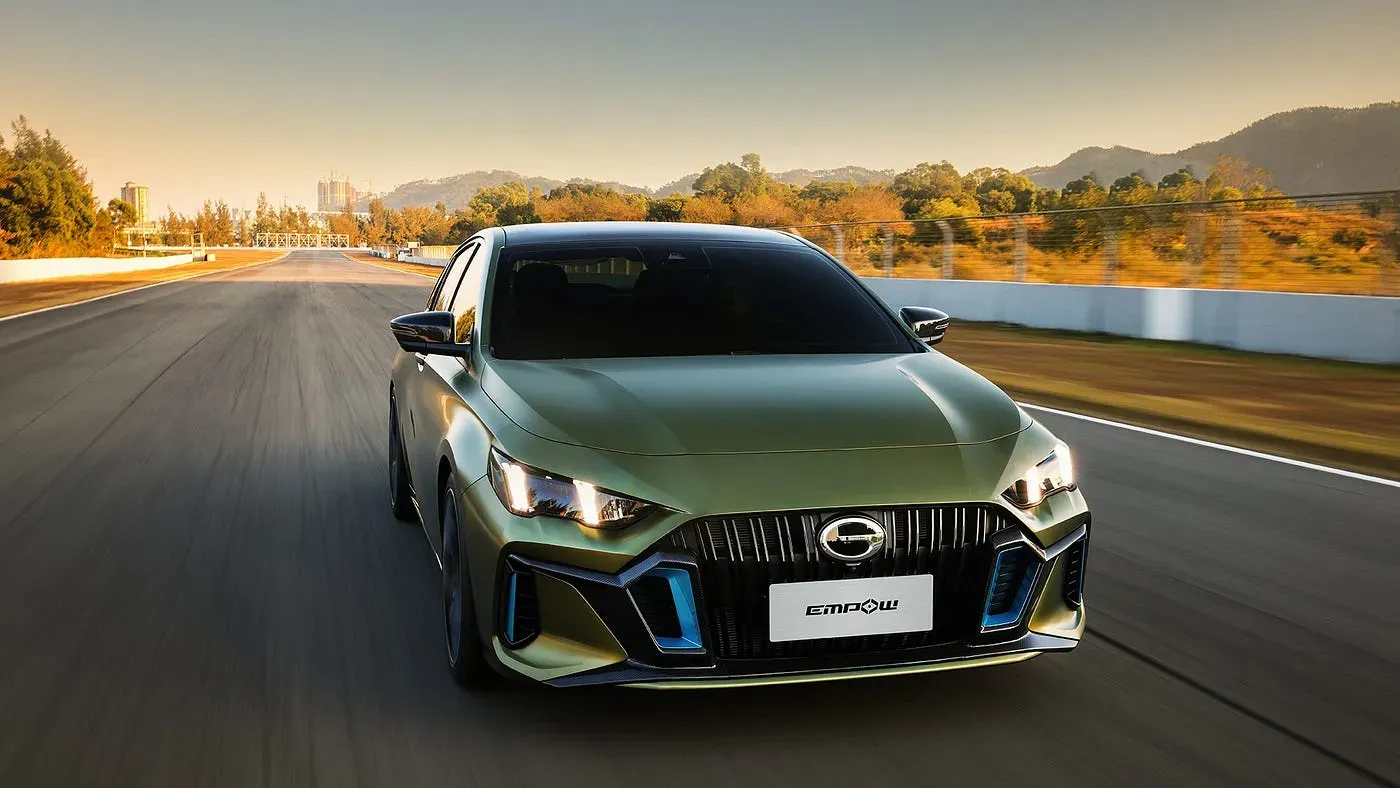 green car driving on a road